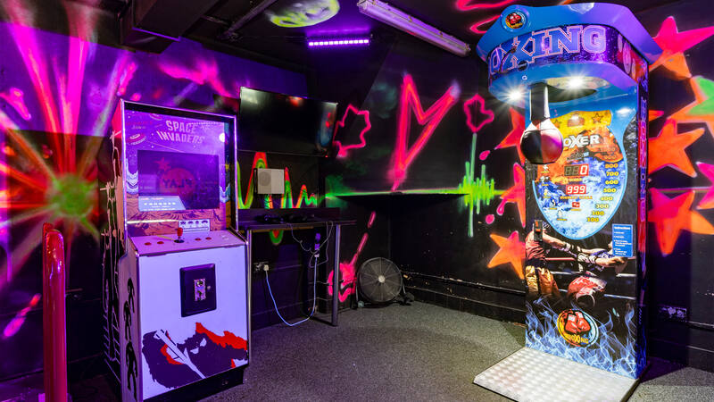 The boxing machine beside a Space Invaders cabinet